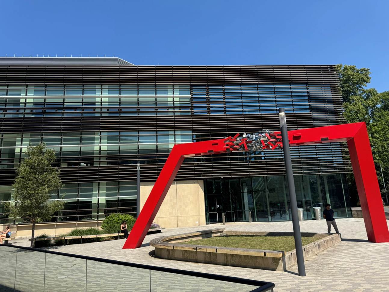A building with a red pole

AI-generated content may be incorrect.